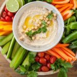 Homemade hummus with caramelized onions and crudités